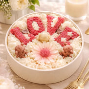 Caramel Apple Creme decorative candle with LOVE design and floral wax accents.