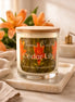 Clear glass jar candle with wooden lid labeled "Phoenix Crafted Cedar Lily".