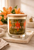 Clear glass jar candle with wooden lid labeled "Phoenix Crafted Cedar Lily".