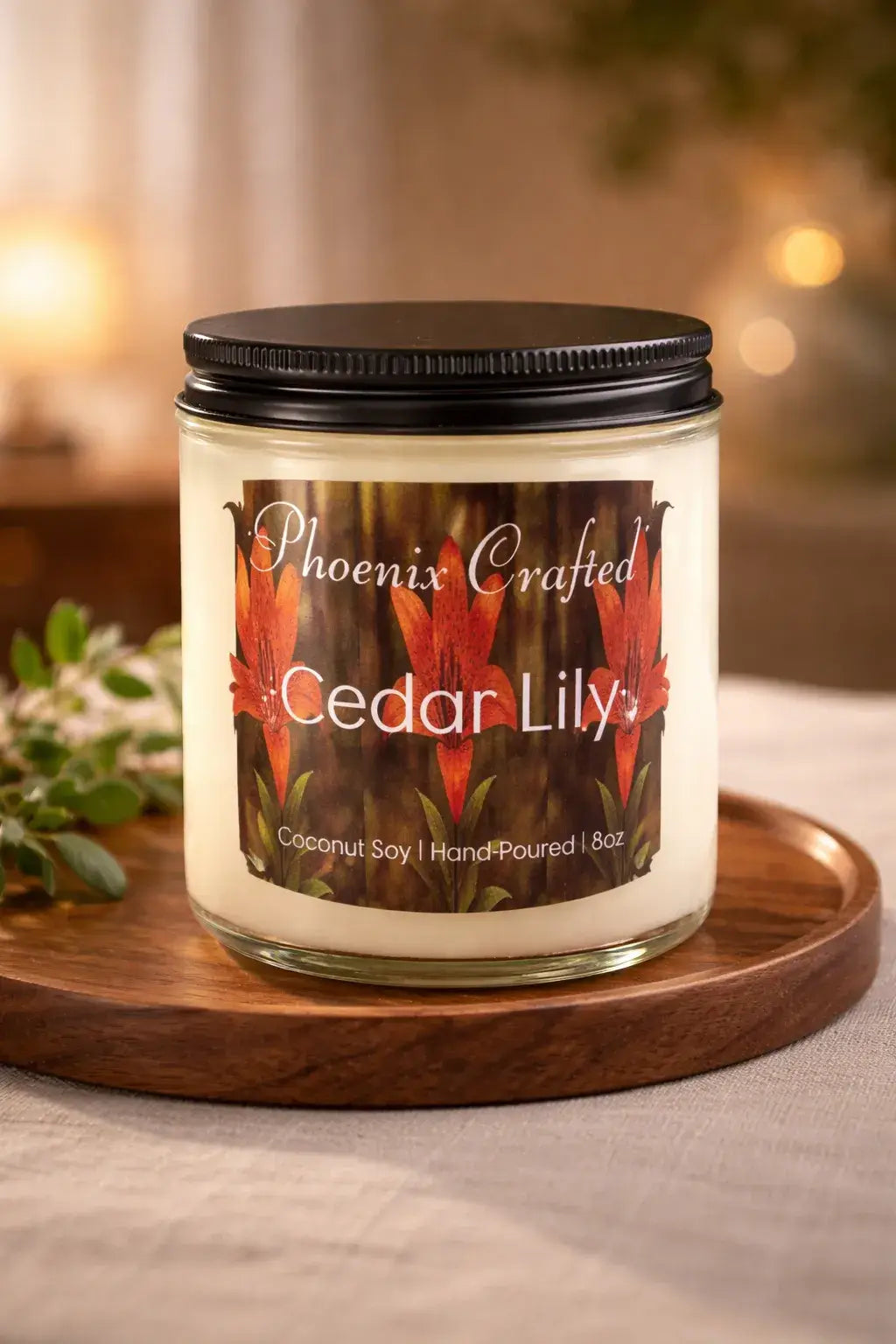 Cedar Lily Candle in a glass jar with vibrant floral label on a wooden tray.