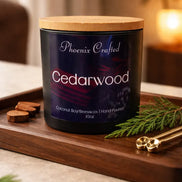 Black jar with a navy label and light lid on a tray with a pine sprig, round slices and small scoops.