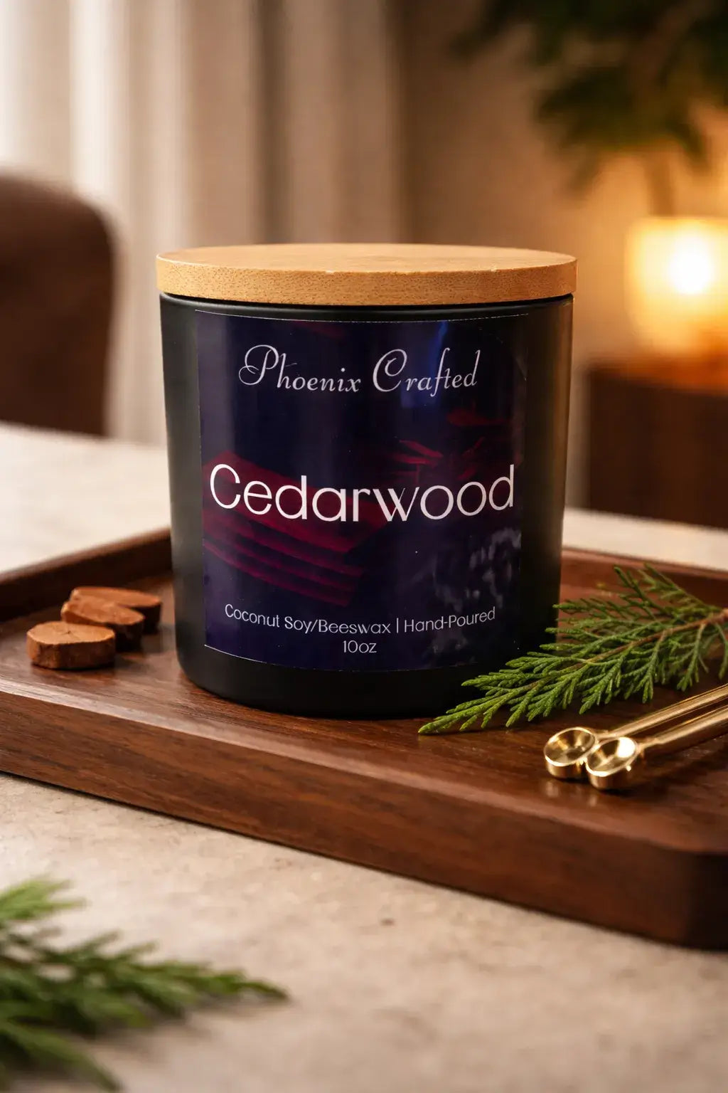 Black jar with a navy label and light lid on a tray with a pine sprig, round slices and small scoops.