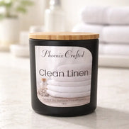 Clean Linen Candle from Phoenix Crafted in a stylish black jar with a wooden lid, ideal for freshening up spaces.