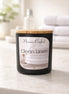 Clean Linen Candle from Phoenix Crafted in a stylish black jar with a wooden lid, ideal for freshening up spaces.