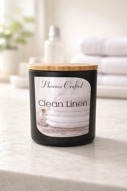 Clean Linen Candle from Phoenix Crafted in a stylish black jar with a wooden lid, ideal for freshening up spaces.