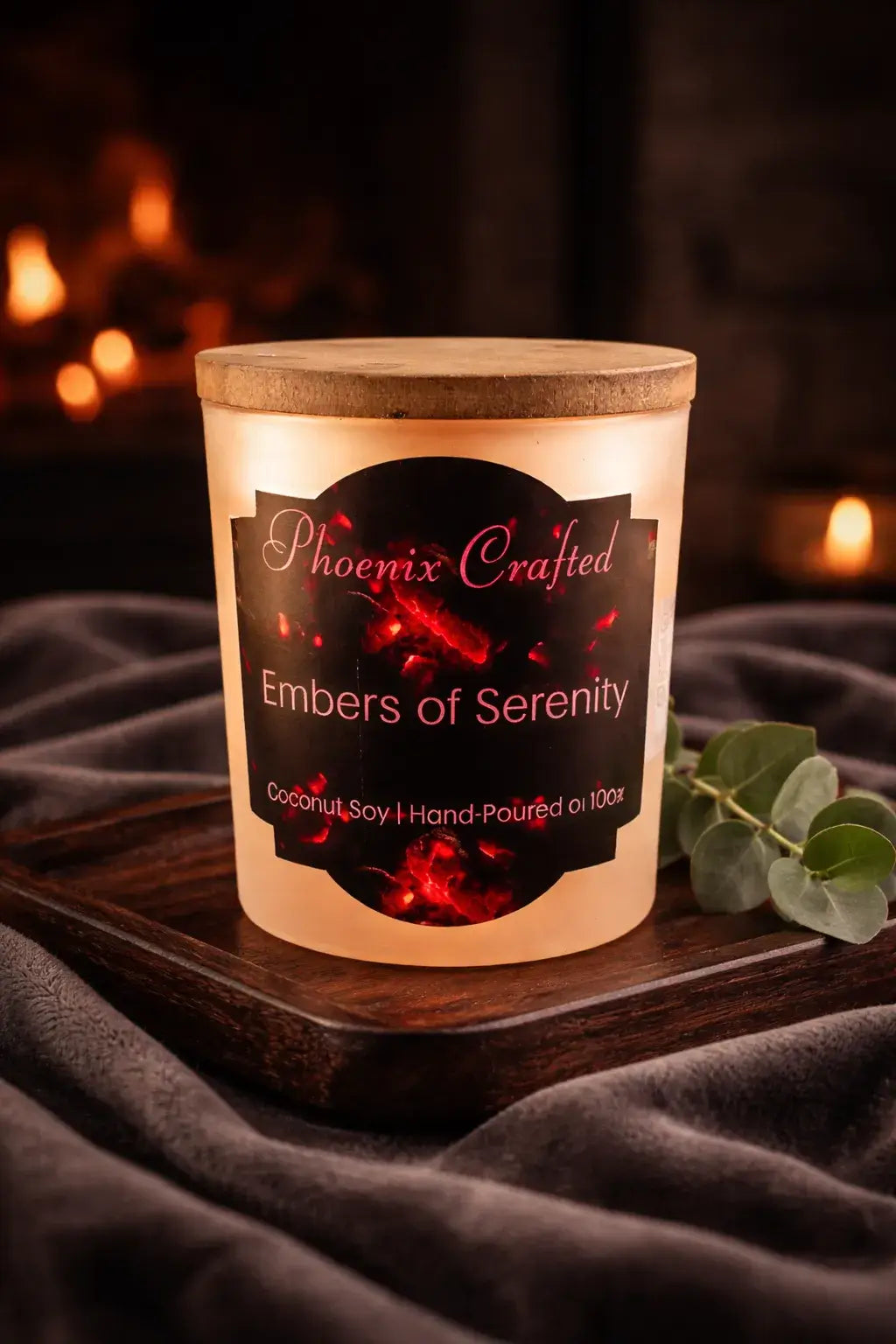 Embers of Serenity Candle in a decorative container with a artisan label, set against a warm, glowing background.
