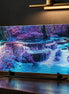 Rectangular diamond painting on a black metal stand showing a purple and blue waterfall mosaic.