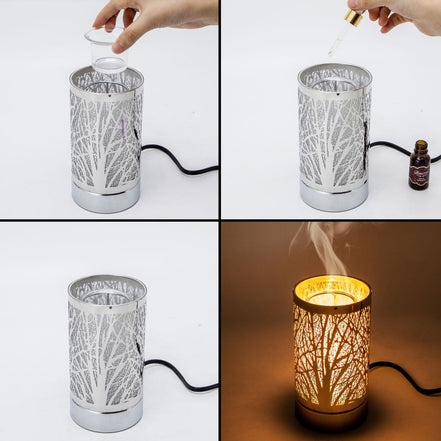 Silver cylindrical wax warmer with tree-branch cutout pattern and black power cord; shown with a clear plastic cup, dropper and bottle.
