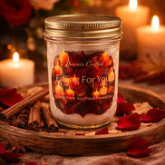 Falling For You Candle in a glass jar surrounded by rose petals and candles, creating a romantic autumn ambiance.