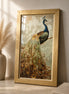 Gold-framed diamond-style peacock painting with a blue head and green-brown tail leaning on a stone tabletop beside a beige vase of pampas grass.