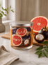 Grapefruit & Mangosteen Candle with vibrant grapefruit and mangosteen displayed on a kitchen counter.