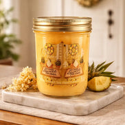 Yellow jar candle with gold screw-top lid labeled 