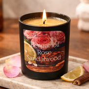 Bergamot Rose & Sandalwood candle on a marble tray with rose petals, lemon, and cinnamon.