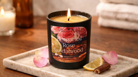 Bergamot Rose & Sandalwood candle on a marble tray with rose petals, lemon, and cinnamon.
