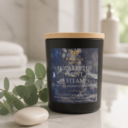 Eucalyptus Mint Steam candle in a matte black vessel styled with fresh eucalyptus, mint, and spa-inspired greenery.