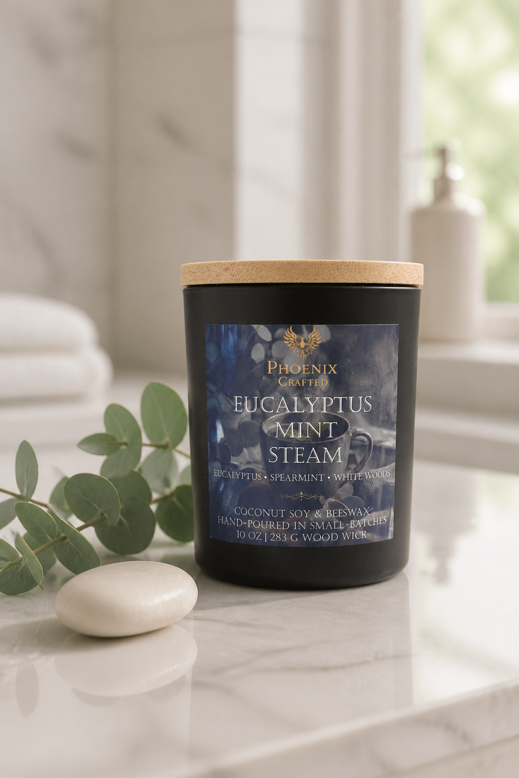 Eucalyptus Mint Steam candle in a matte black vessel styled with fresh eucalyptus, mint, and spa-inspired greenery.
