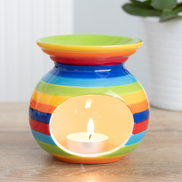 Rainbow Wax Melt Essential Oil Burner Warmer with a colorful striped design and lit tea light candle inside.