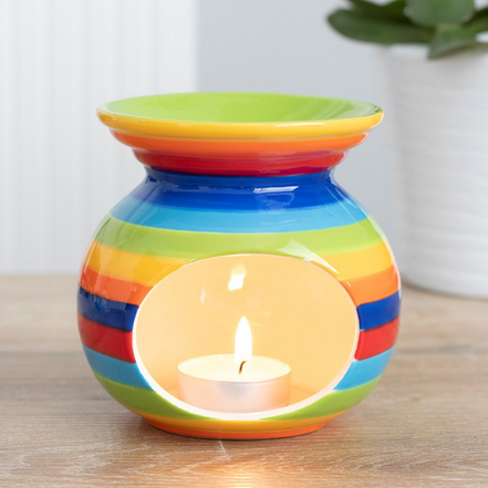 Rainbow Wax Melt Essential Oil Burner Warmer with a colorful striped design and lit tea light candle inside.