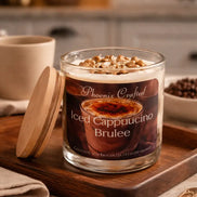 Iced Cappuccino Brûlée Candle in a glass jar on a wooden tray with decorative elements and a cozy kitchen background.