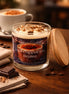 Iced Cappuccino Brûlée Candle in a glass jar with a wooden lid, surrounded by coffee beans and chocolate.