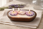 Lavender candle trio with floral designs, hand-poured in a wooden container, perfect for relaxation.