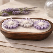 Lavender Candle with lavender flowers in a wooden dish, creating a serene and calming atmosphere for relaxation.