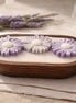 Lavender Candle with lavender flowers in a wooden dish, creating a serene and calming atmosphere for relaxation.