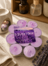 Lavender Tealights pack with hand-poured candles in a cozy setting, showcasing their soft purple glow.