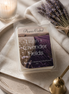 Linen & Lavender Fields Wax Melts packaging on a wooden tray with lavender flowers and a candle