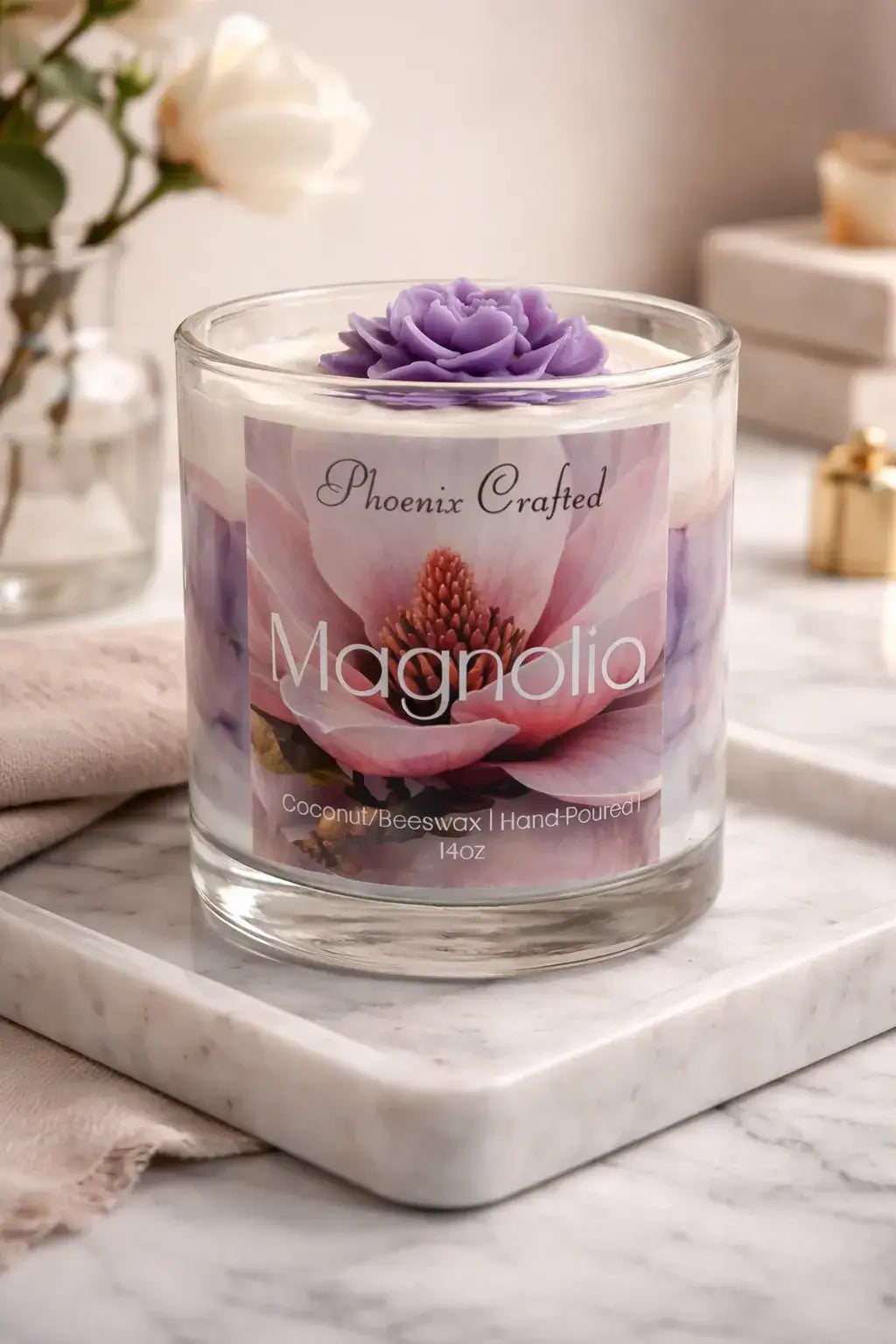 Magnolia Candle in a glass jar with floral design and purple flower on top, perfect for creating a calming atmosphere.