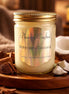 Mahogany Coconut Candle in a jar with polished design, surrounded by coconut and wood pieces.