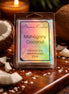 Clear clamshell wax melt pack with holographic label reading “Phoenix Crafted” and “Mahogany Coconut,” on a wooden board with coconut halves, flakes.