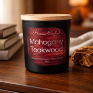 Black matte candle jar with a light wood lid and red wood-grain label reading 