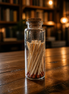 Cork match jar with 30 matchsticks displayed on a rustic wooden table, ideal for candle lighting.