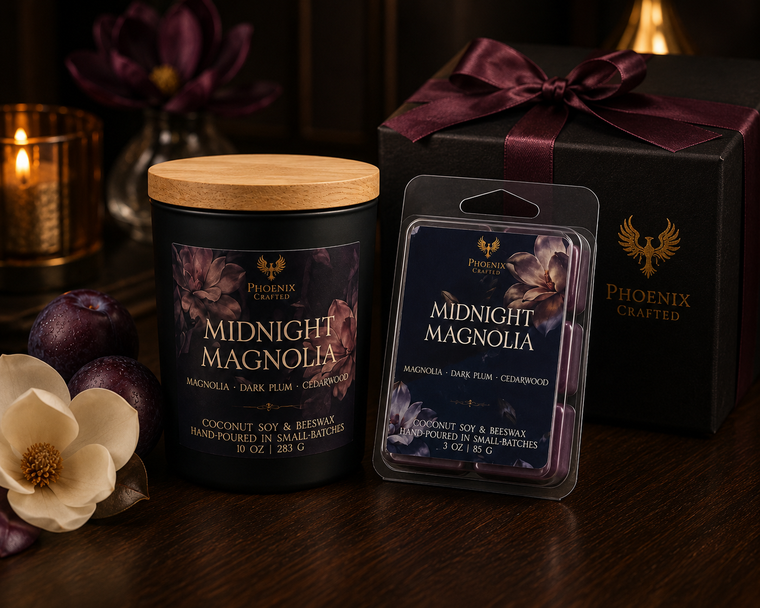 Midnight Magnolia candle and wax melt gift set with a black gift box and burgundy ribbon, styled with plums and magnolia flowers.
