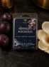 Midnight Magnolia wax melts in a clear clamshell package styled with dark plums and a magnolia flower.