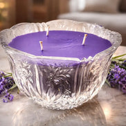 Moonlight Vanilla Candle in a decorative glass bowl surrounded by lavender flowers.
