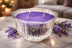 Moonlight Vanilla Candle in a decorative glass bowl surrounded by lavender flowers.