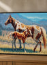 Mountain Meadow Duo mare-and-foal diamond artwork shown in a styled black-frame mockup; artwork is sold unframed.