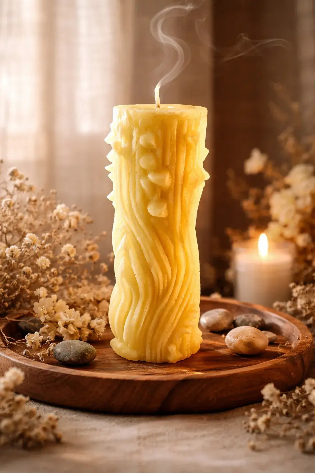 Decorative Naked Berry Candles with a playful design and warm, tropical scent on a wooden platter.