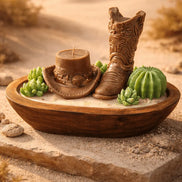 Palo Santo Cedarwood & Patchouli Candle Decorative holder featuring a cowboy boot and hat with succulents in a rustic setting.
