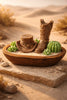 Palo Santo Cedarwood & Patchouli Candle Decorative holder featuring a cowboy boot and hat with succulents in a rustic setting.