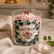 Rose Water & Ivy Candle displayed on a marble surface with rose petals and a soft fabric.