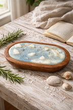 Sea Salt & Rosemary Candle displayed on rustic wood table with seashells and rosemary accents, evoking a coastal vibe.