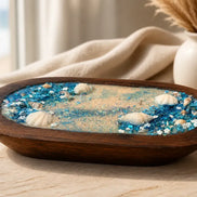 Sea Salt & Rosemary Candle displayed in a wooden tray with shells and blue crystals, evoking a coastal vibe.