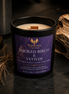 Smoked Birch & Vetiver candle in a dark Phoenix Crafted vessel with a smoky wood-inspired setting.