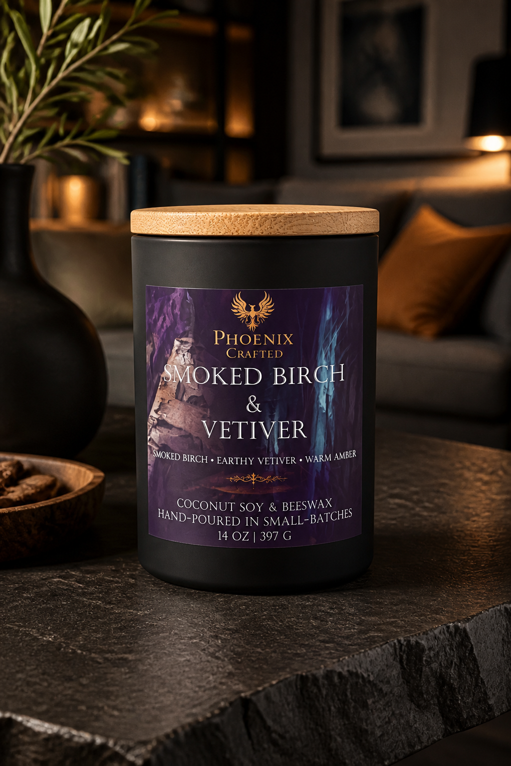 Smoked Birch & Vetiver Noir Grande 14 oz candle in a matte black vessel styled with dark woods and warm amber accents.
