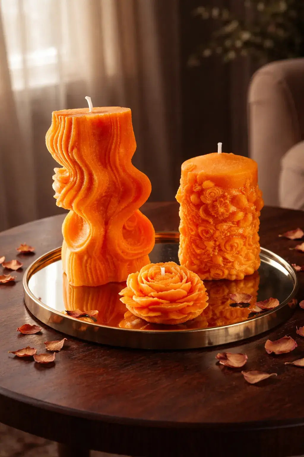 Decorative Sparkling Blossom Candles in vibrant orange hues, showcasing floral designs on a stylish tray.