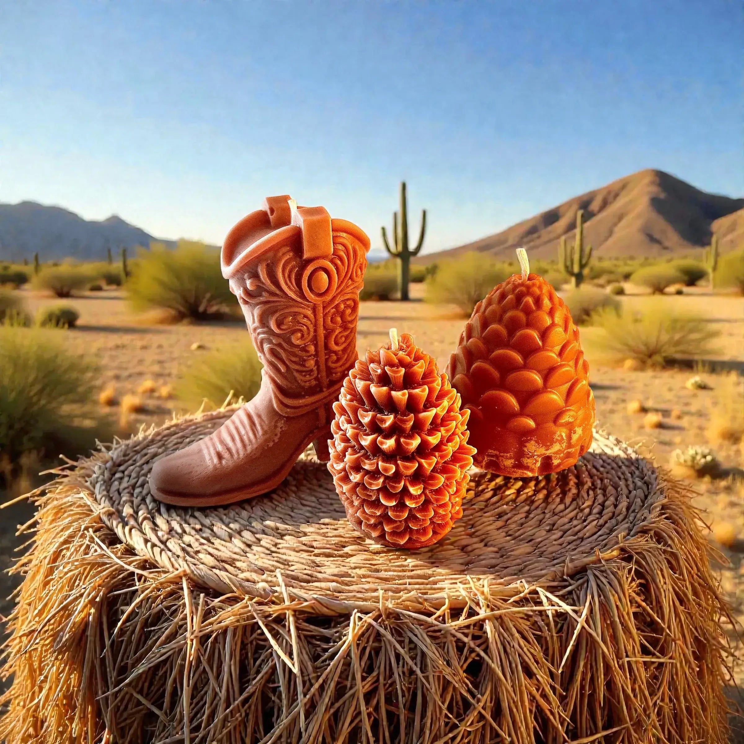 Decorative Speakeasy Candles showcased on a straw surface, featuring a cowboy boot, pinecone, and cactus backdrop.