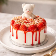 Strawberry Cheesecake Candle with a cute teddy bear and strawberries on top on a stylish platter.